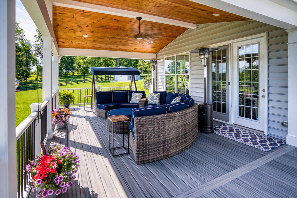 Open porch with gable roof and ceiling fan by Deckscapes of VA