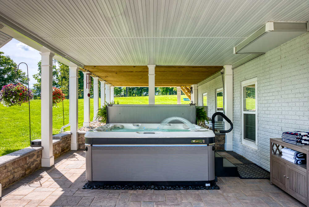 Hot tub in under deck living space by Deckscapes of VA