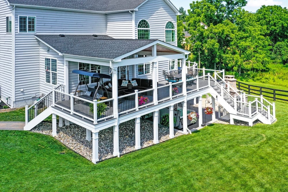 Raised deck with open porch and under deck living space by Deckscapes of VA