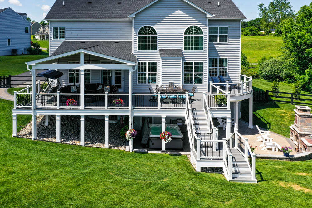 Raised deck with open porch and under deck living space by Deckscapes of Virginia