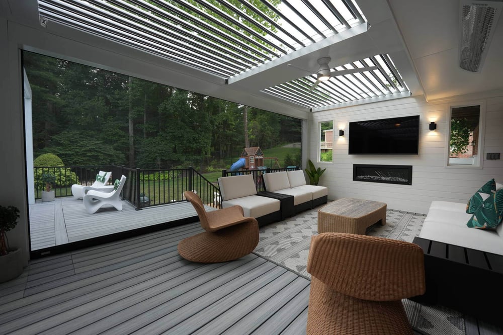 Contemporary covered patio struxure pergola with comfortable lounge chairs and TV, designed by Deckscapes of Virginia