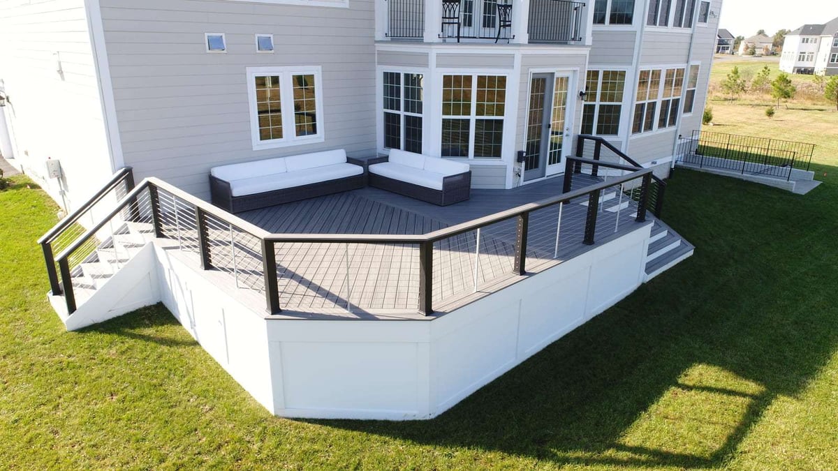 Custom deck with cable railing and seating at a home in Northern Virginia