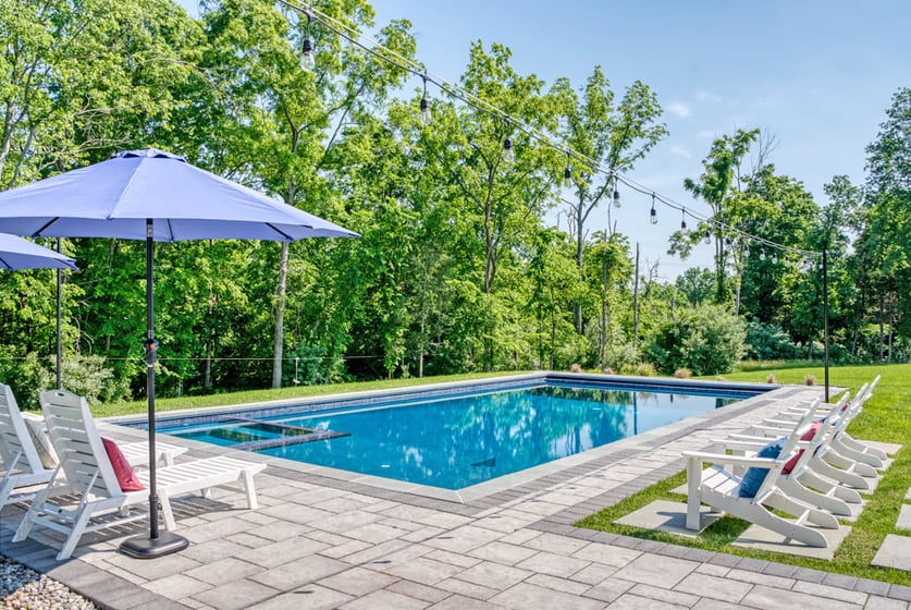 Custom in-ground pool in Northern Virginia on sunny day with chairs
