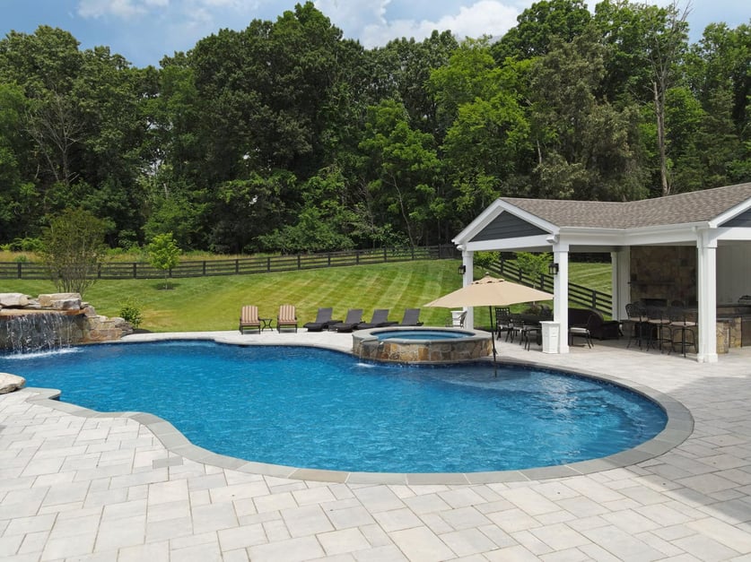 Custom pool and jacuzzi next to pavilion in Northern VA backyard