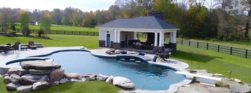 Custom pool house with fireplace and stone veneers by Deckscapes of VA 