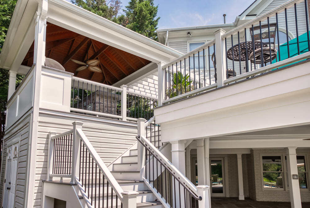 Deck railing and steps with white trim by Deckscapes of VA