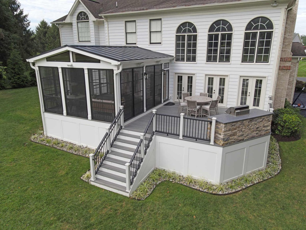 Deck with grill and stone accents and screened in porch in Norhtern Virginia