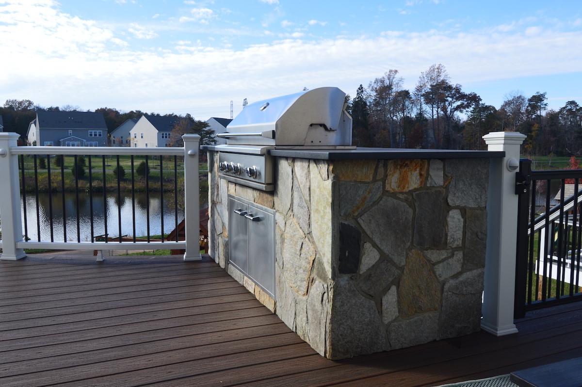 Outdoor Kitchen With Custom Stone Siding on Deck