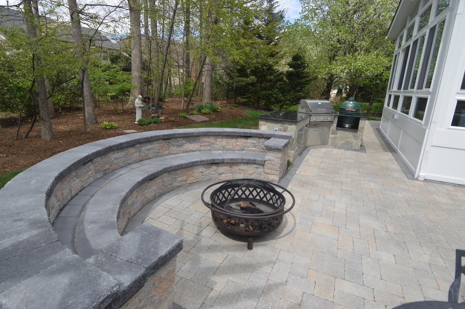 Patio and built-in stone seating wall with outdoor kitchen