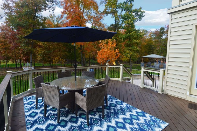 custom deck area with outdoor table and chairs