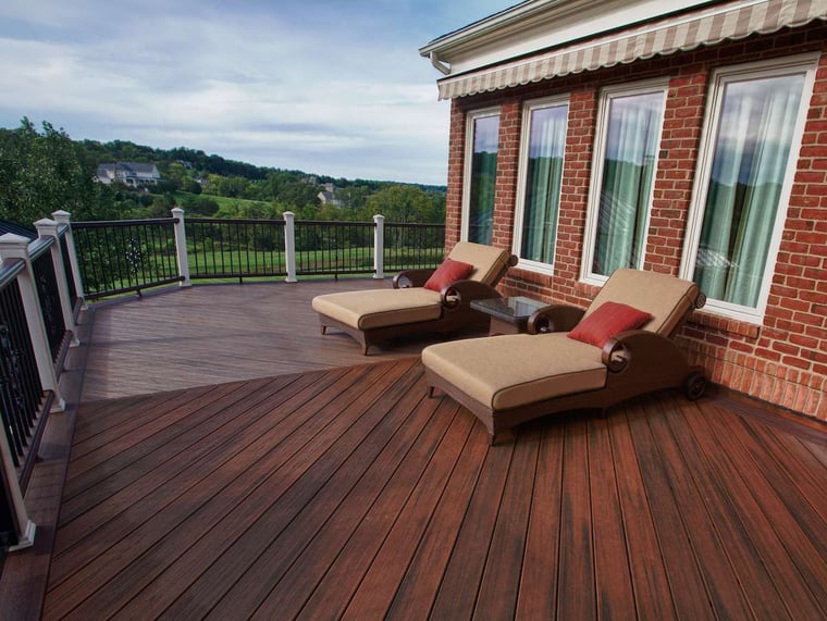 custom raised deck with chevron pattern decking and two chairs
