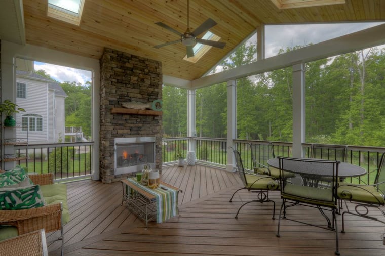Porch interior with skylights on vaulted ceiling and stone fireplace