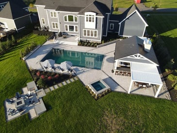 Drone view of round deck with dining, lounging, and barbecue area, designed by Deckscapes of Virginia