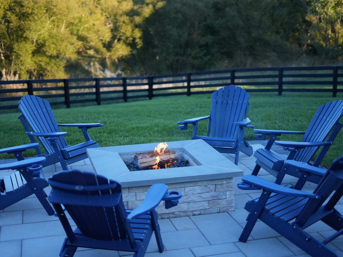 square stone firepit surrounded by chairs in VA by Deckscapes