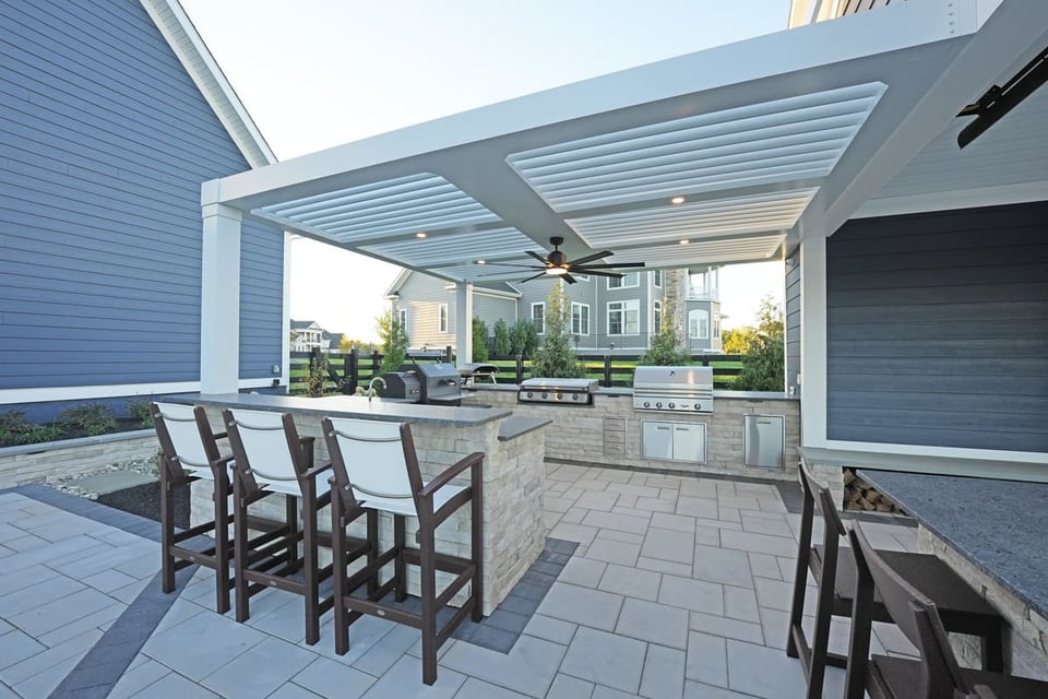 Bar seating in an outdoor kitchen with custom patio in VA by Deckscapes