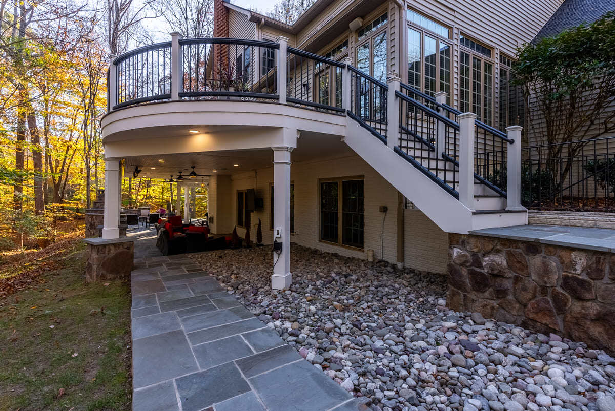 Under deck drainage with stone pathway by Deckscapes of Virginia