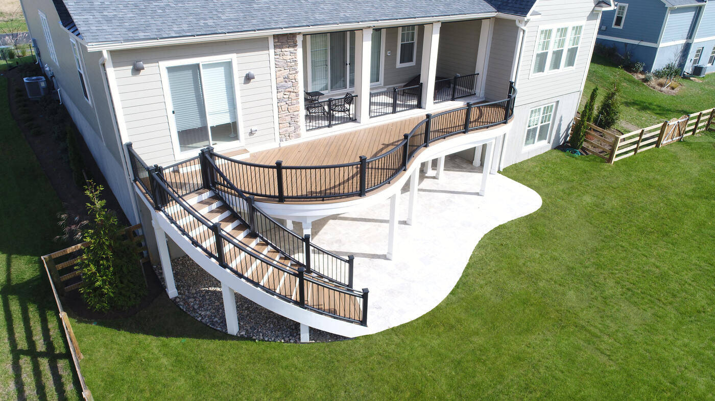 Elevated custom deck with curved staircase designed by Deckscapes of Virginia in Northern Virginia Elevated custom deck with curved staircase designed by Deckscapes of Virginia in Northern Virginia