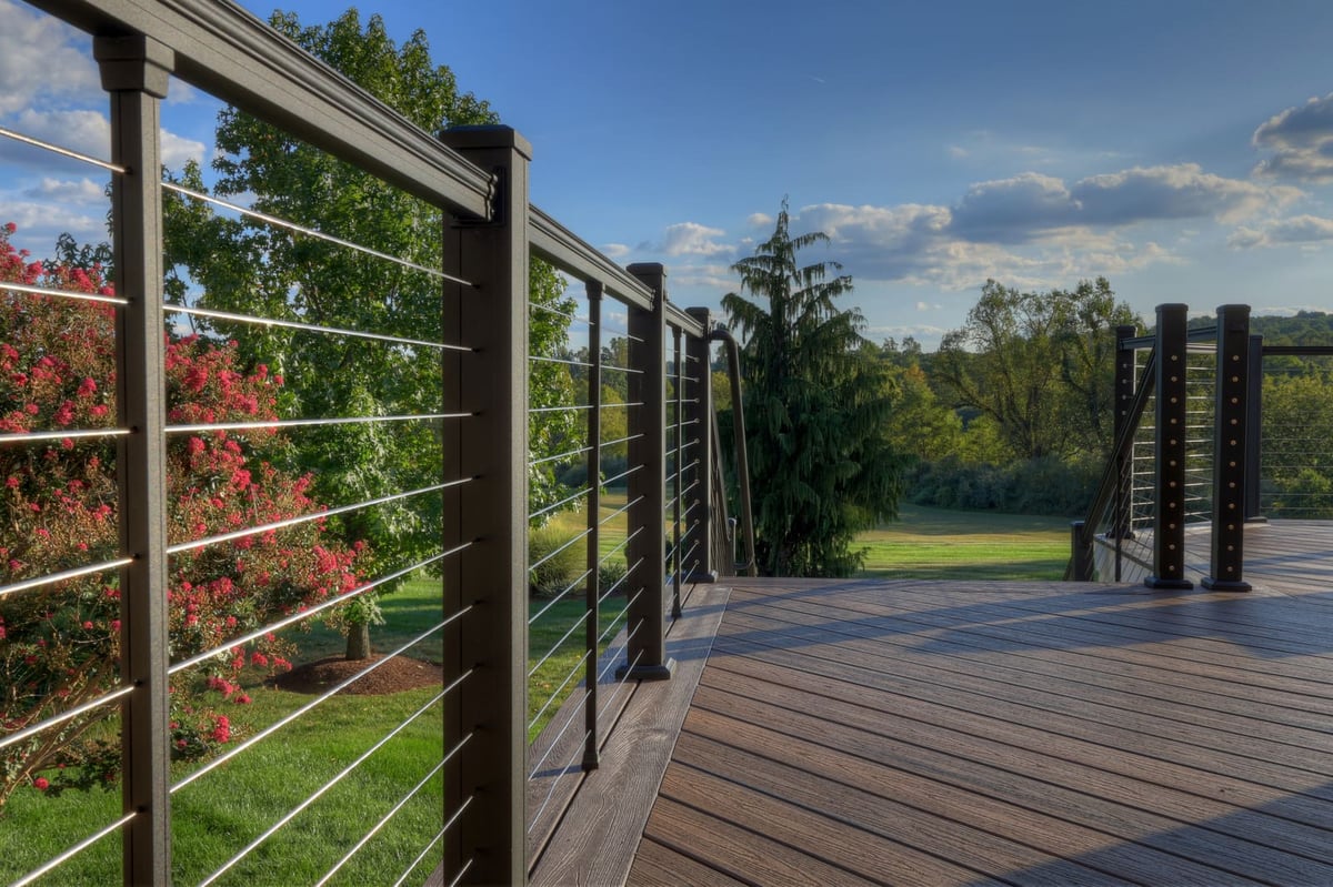 Cable railing on two-story composite deck by Deckscapes of Virginia
