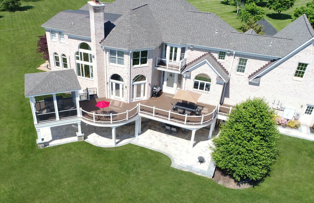 Drone view of curved deck with screened-in porch by Deckscapes of VA