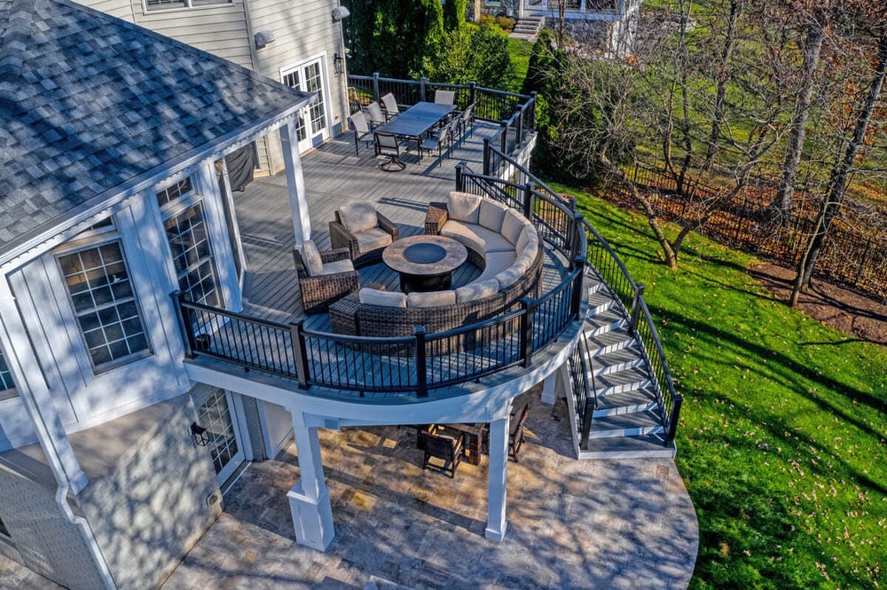 Drone view of two-story curved deck and furniture by Decksapes of Virginia