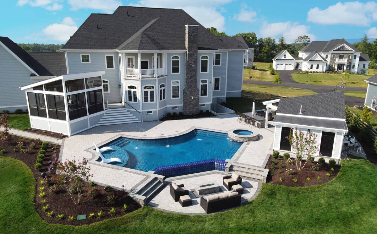 Pool house, pool, and patio by Deckscapes of VA