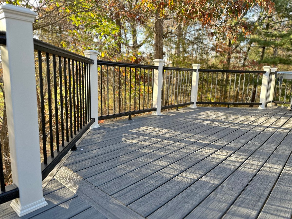 Railing design on raised deck with white posts by Deckscapes of VA