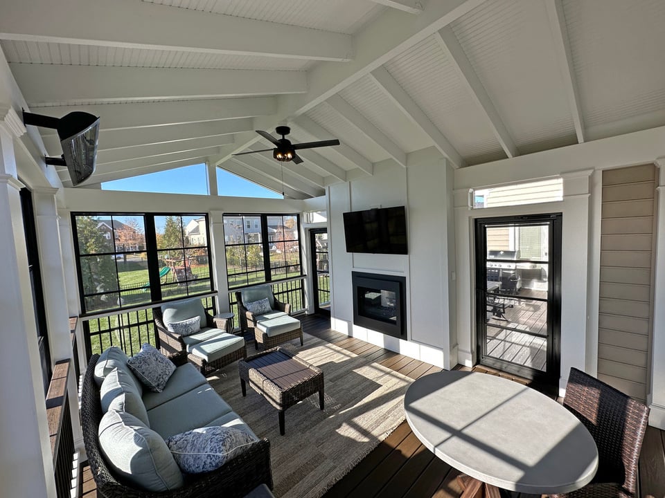 Screened-in porch with fireplace and a-frame roof by Deckscapes of VA