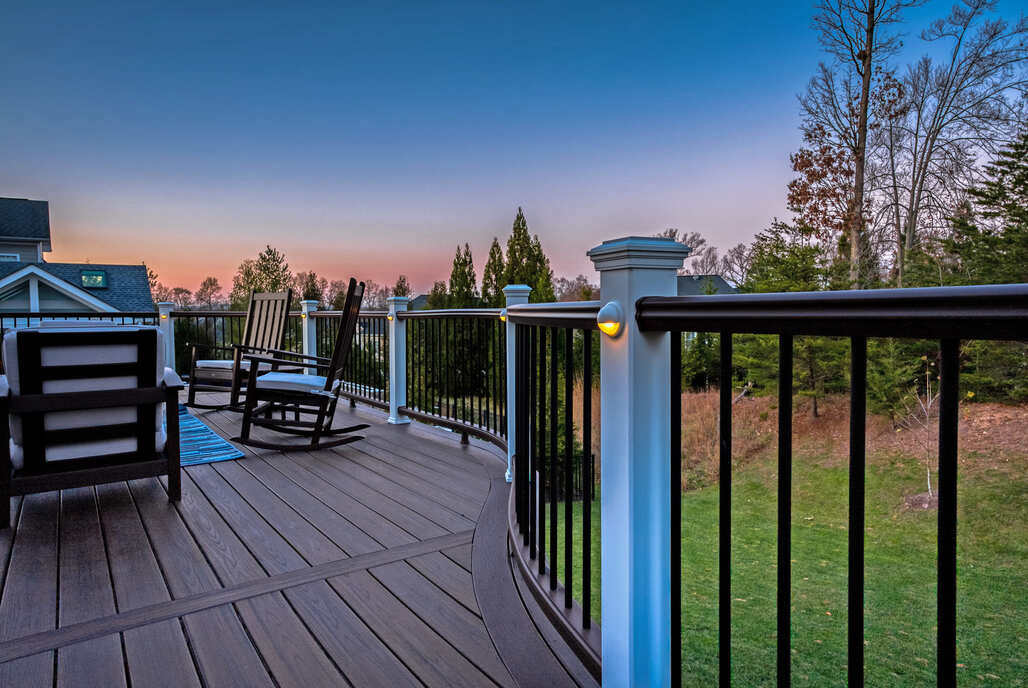 Sunset view from custom built deck with curved railing by Deckscapes of Virginia