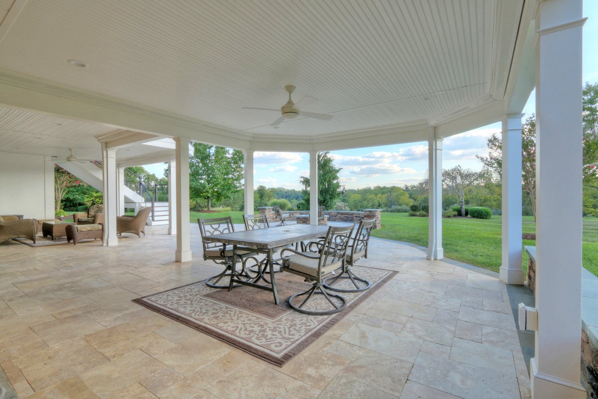 Under deck living space with dining table by Deckscapes of VA