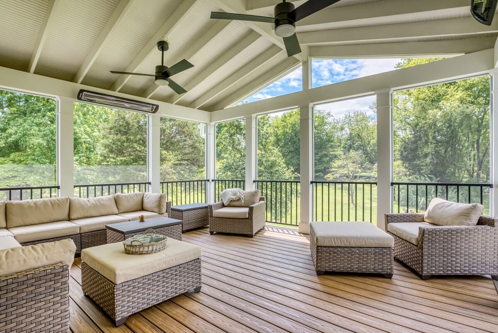 High-end screened-in porch interior with Bromic heaters and furniture