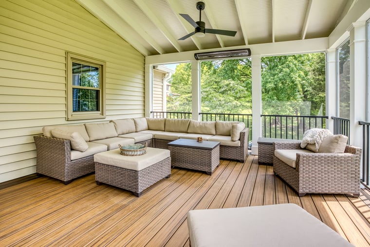 High-end screened-in porch interior with Bromic heaters and furniture
