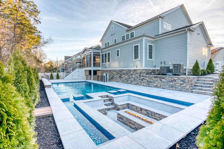 In-ground pool surrounding and underground fire place in Northern Virginia backyard