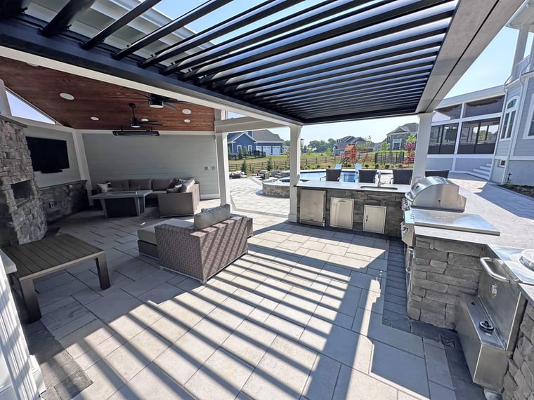 Louvred Struxure pergola attached to pool house over outdoor kitchen
