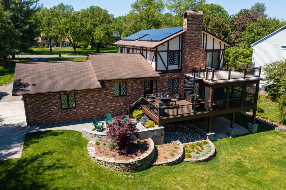 Multi-level deck and patio with covered porch by Deckscapes of Virginia