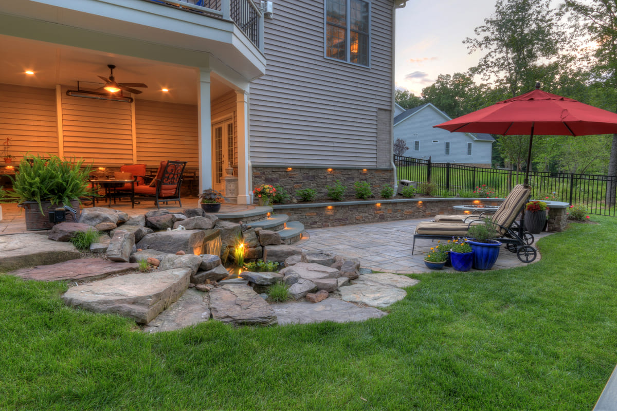 Northern Virginia patio and under deck with custom warm hue lighting by Deckscapes of VA