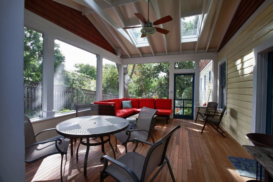 Northern Virginia screened-in porch with wood flooring and red sectional