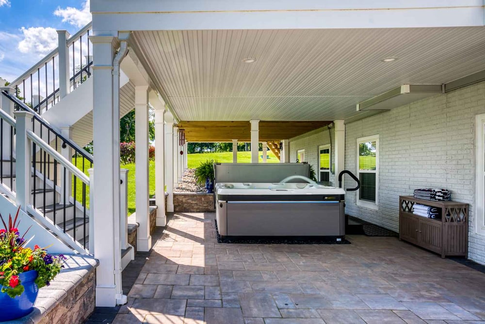 Under deck system with hot tub and recessed lighting on ceiling