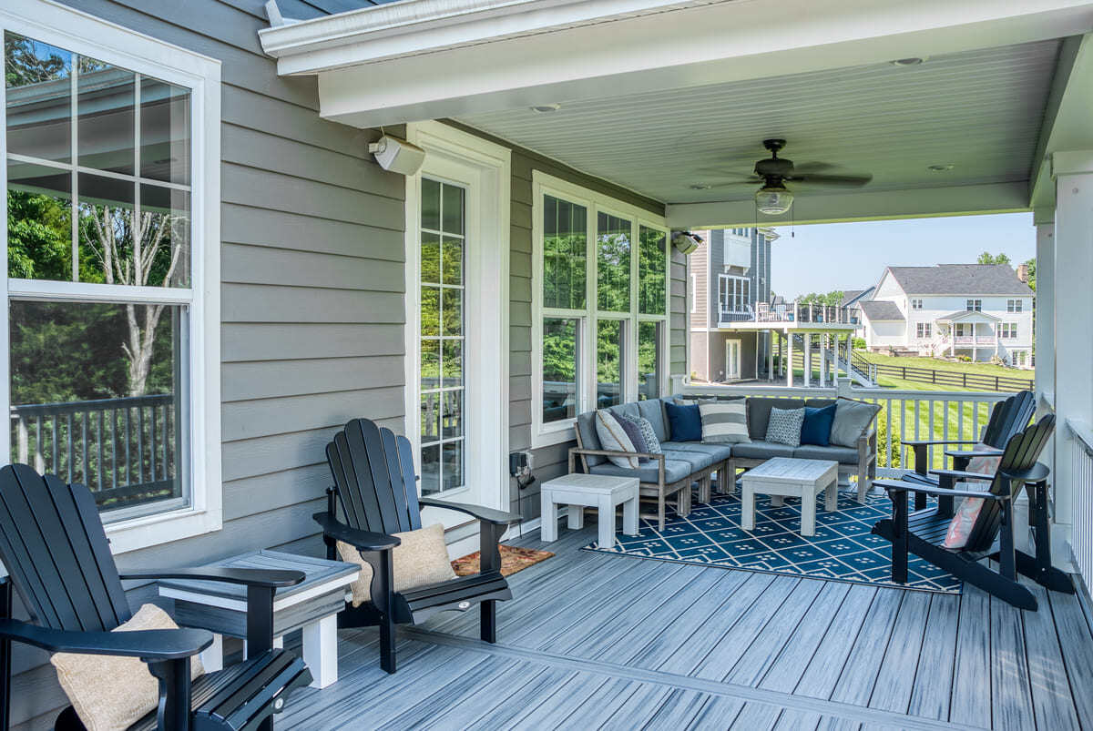 Outdoor furniture on deck with blue accents and throw pillows