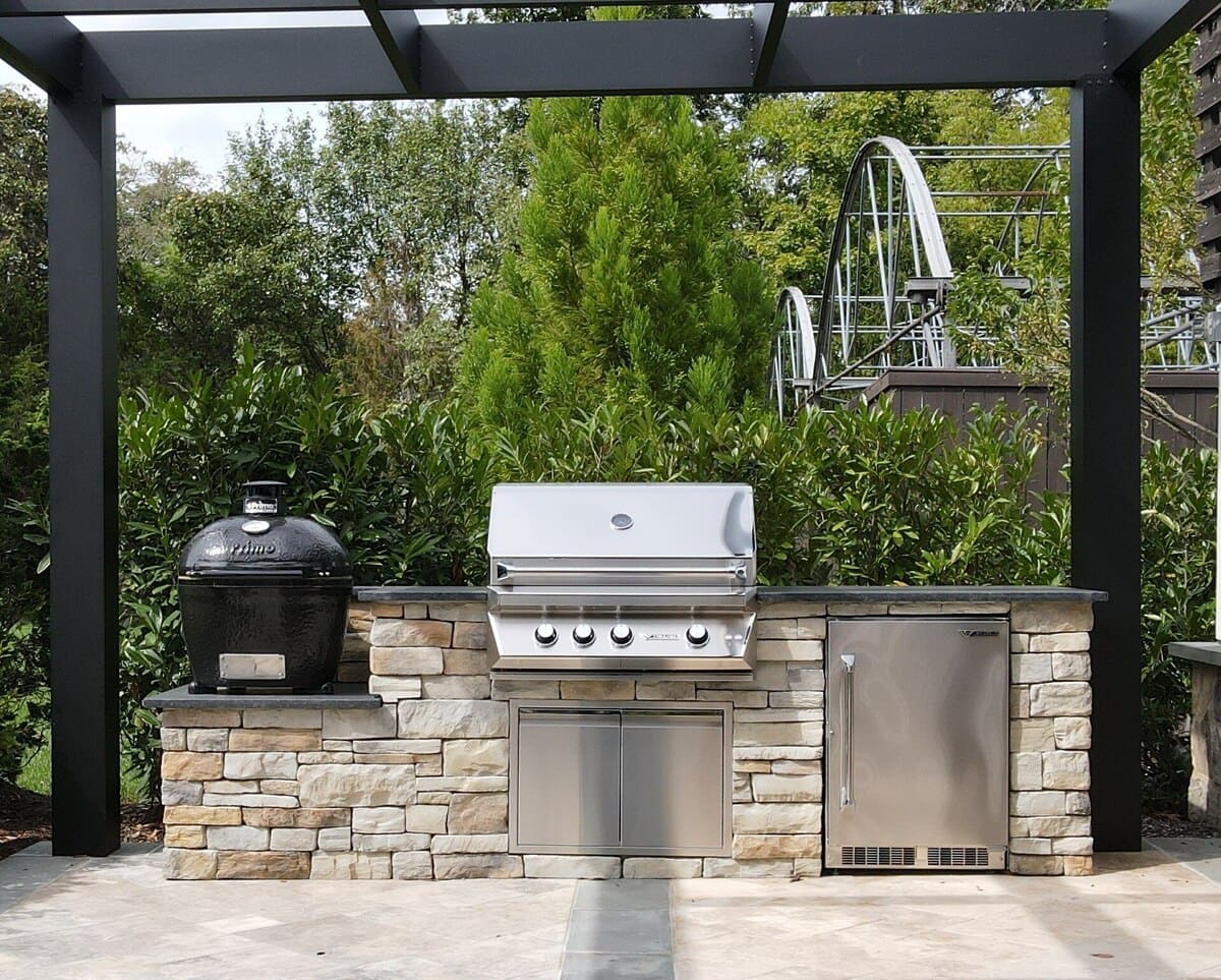 Outdoor kitchen with grill and smoker by Deckscapes of Virginia