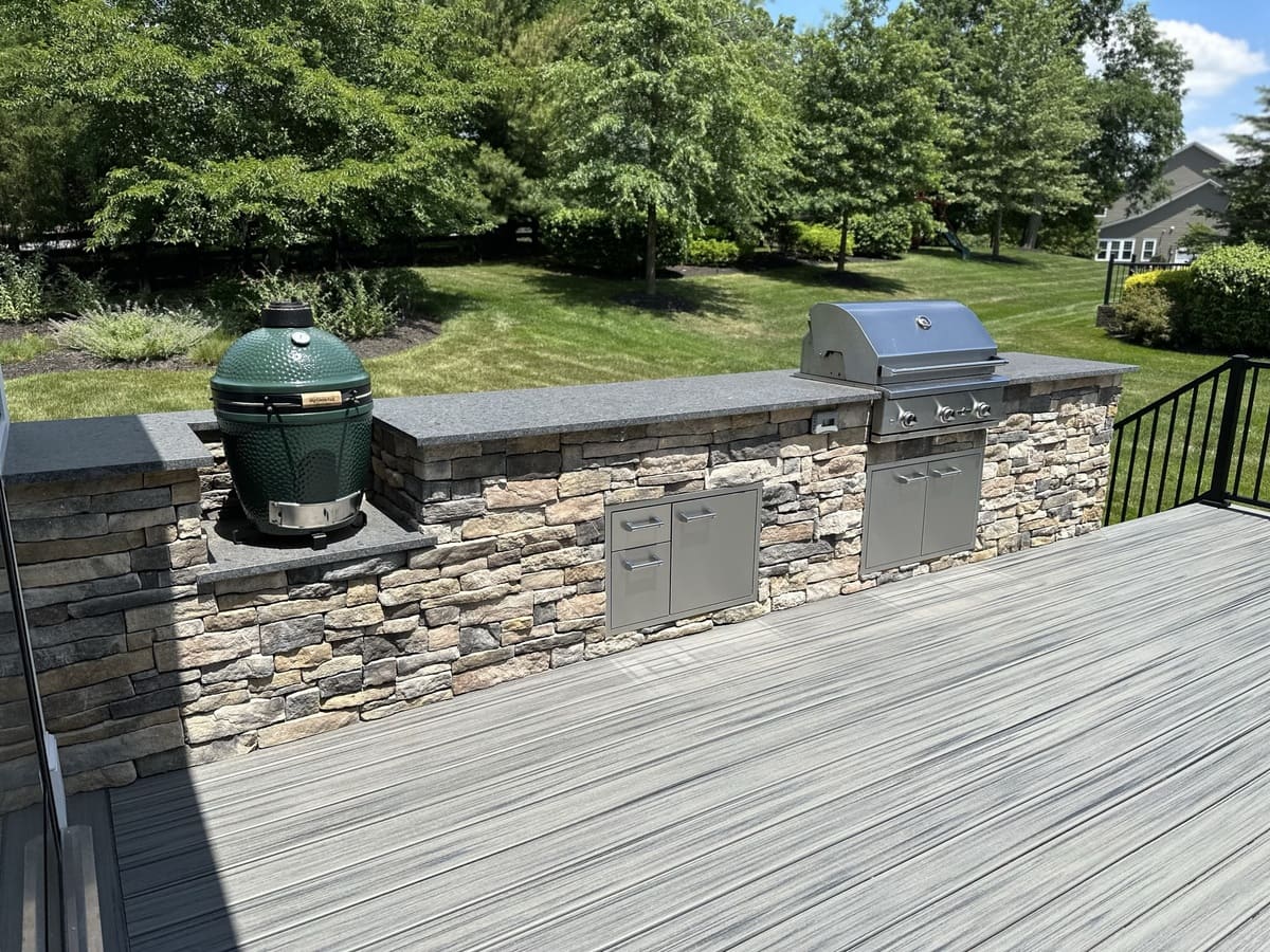 Outdoor kitchen with grill and smoker on deck by Deckscapes of Virginia