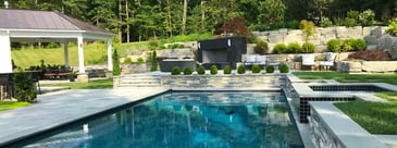 Multi-level patio, pavilion, and pool with landscaping design by Deckscapes of Virginia