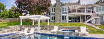 Pergola over patio near gunite pool with deck in back by Deckscapes of VA