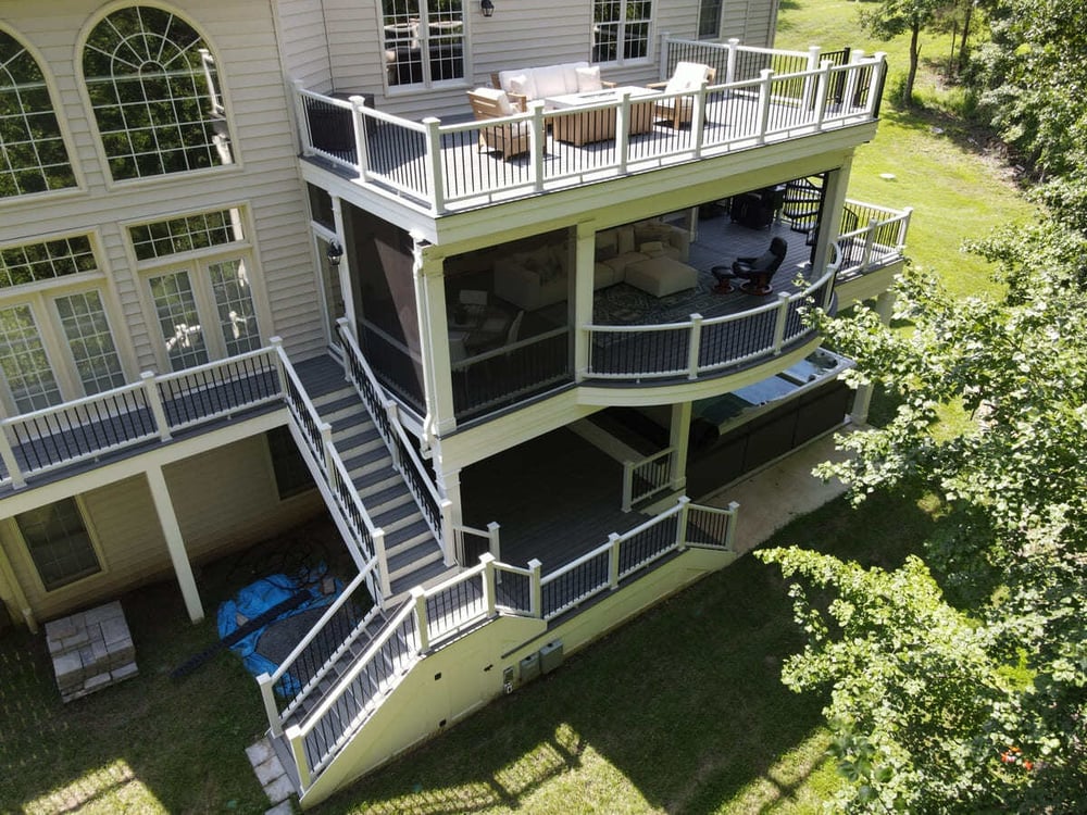 Drone view of multi-level deck with covered ground level by Deckscapes of Virginia