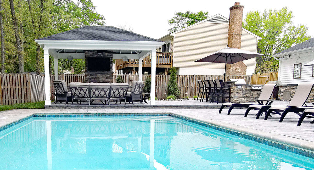 Pool, pool house, and outdoor kitchen by Deckscapes of Virginia