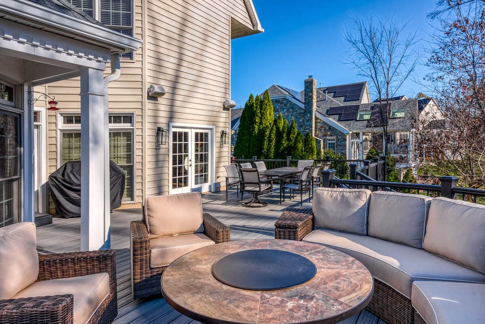 Raised curved deck with fire pit in Northern VA by Deckscapes of Virginia