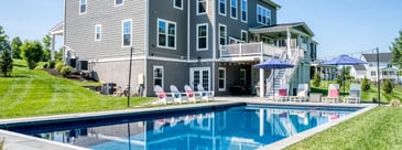 Rectangular pool and raised deck by Deckscapes of VA