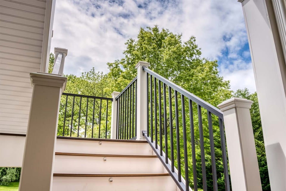 White stair railing with black balusters leading to raised deck in Northern Virginia