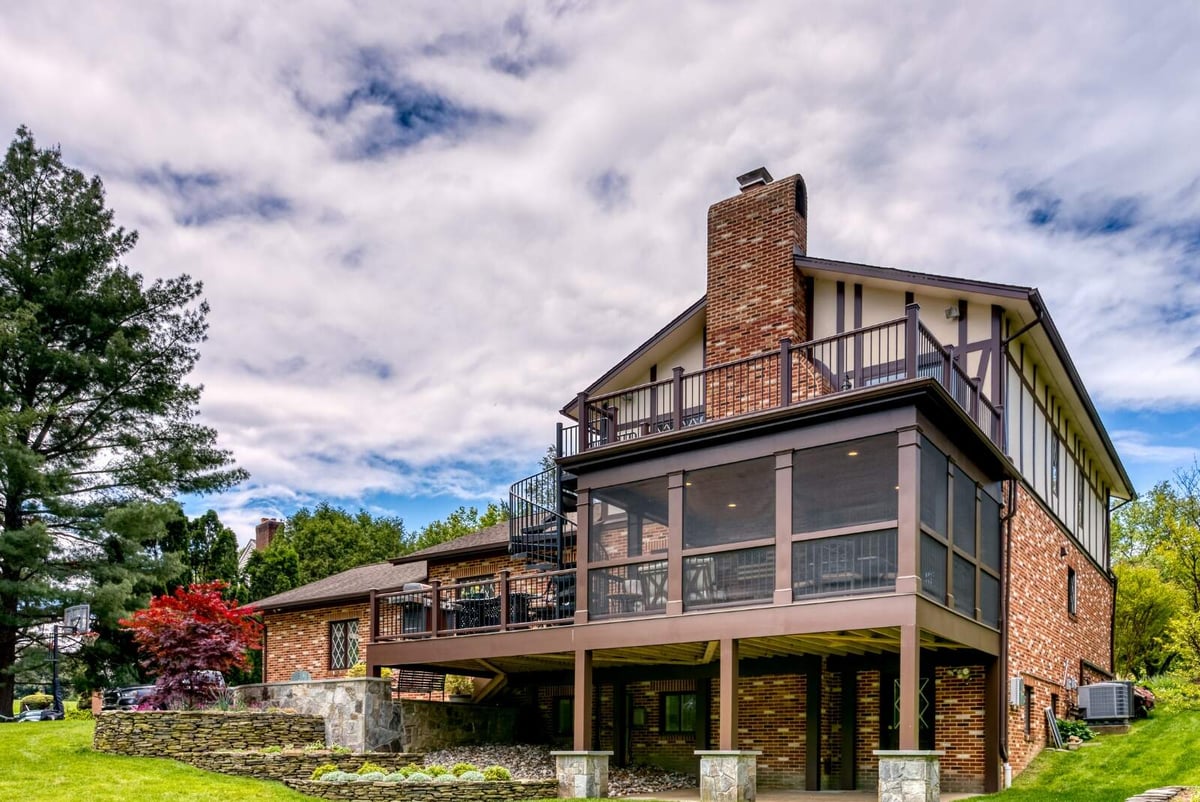 Screened in porch exterior on multi-level deck by Deckscapes of Virginia