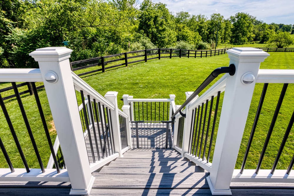 View of deck railing going down to backyard by Deckscapes of Virginia