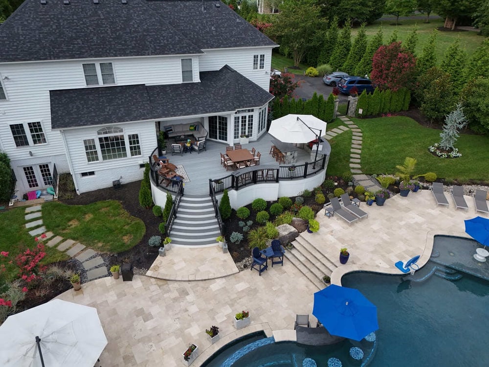 Drone view of curved deck with steps to pool by Deckscapes of VA
